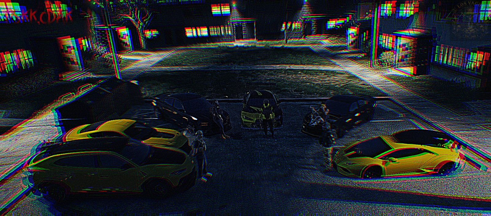 Two yellow Vagos cars parked in the street at night